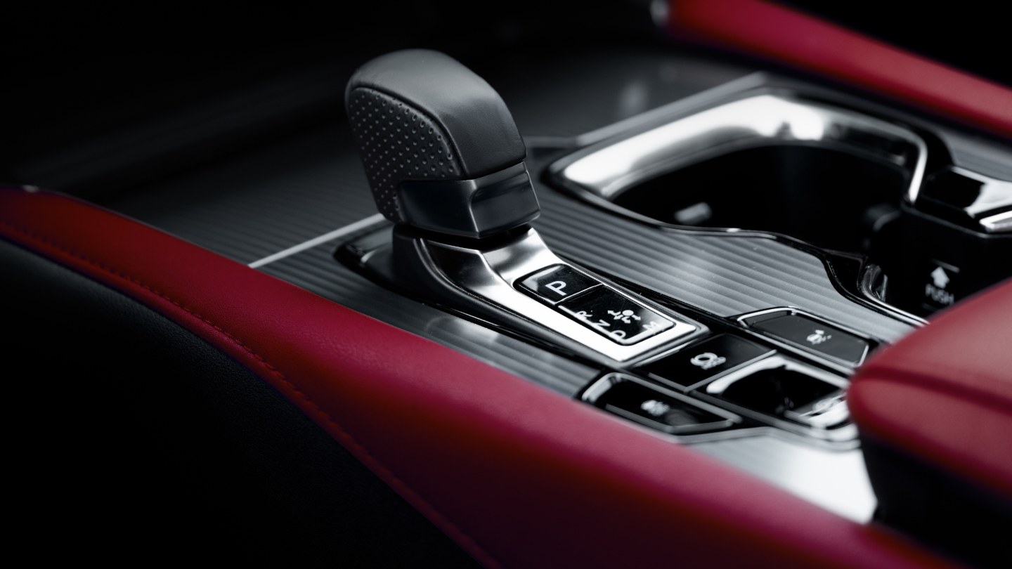 Close-up of the F SPORT perforated leather-trimmed shift knob and Dark Graphite Aluminum trim.